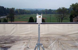 Portable weather station installed on top of a roof.