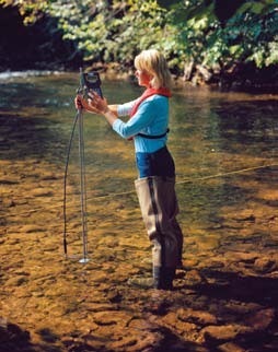 Hydrologist transects a stream with the SonTek FlowTracker and a USGS tagline. The FlowTracker is designed for discharge measurements in wadeable streams and rivers.