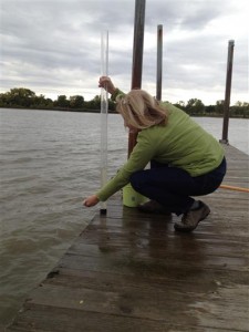 Sea Grant’s Vicky Harris takes a water sample from the Fox River. (Credit: Tracy Valenta, Green Bay Metropolitan Sewerage District)