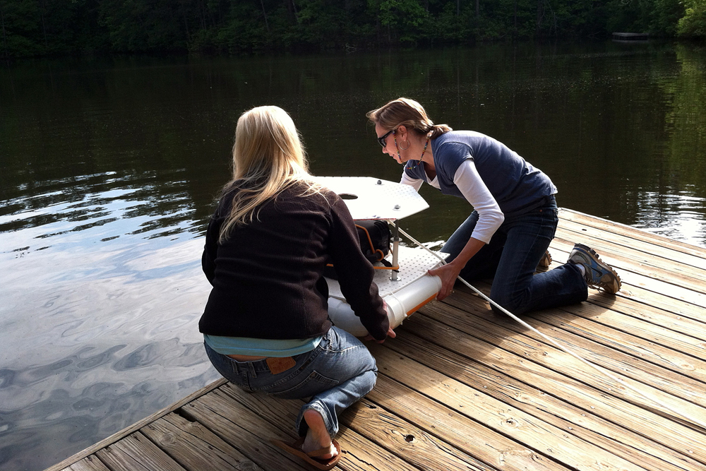 Lisa Adams and student Chelsea Kuykendall work on a buoy near beaver pond at the Chattahoochee Nature Center (Credit: Michael Dias)