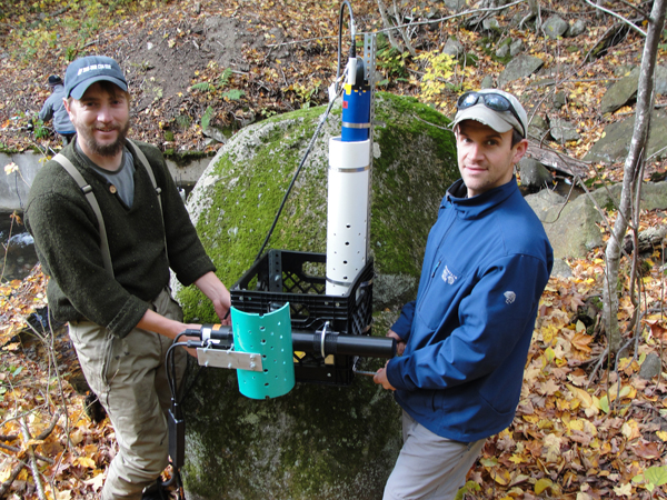 Adam Baumann and Lisle Snyder from the UNH Water Resources Research Center tend a sensor station (Credit: Jody Potter)