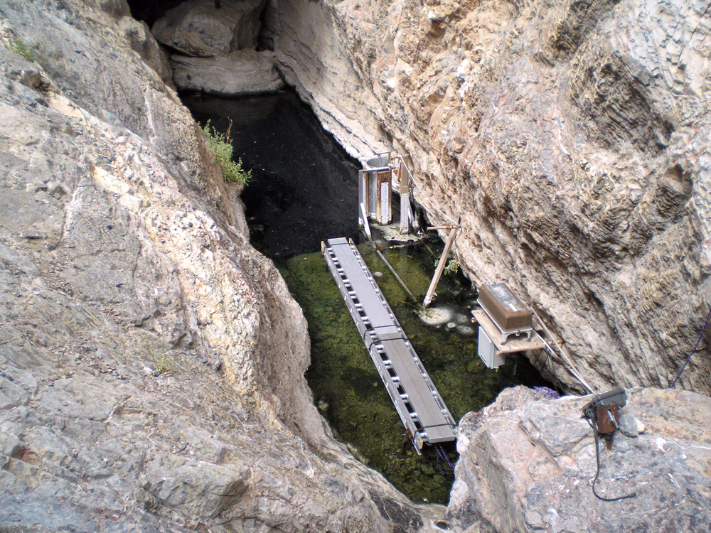 Devils Hole, with the shallow shelf in the foreground and the opening to the cavern in the background (Credit: U.S. Fish and Wildlife Service)