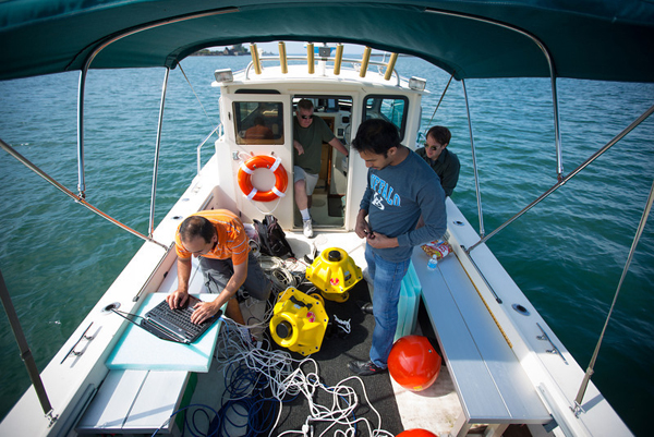 Electrical engineering graduate students Hovannes Kulhandjian and Zahed Hossain in the lab boat of Tommaso Melodiaís WINES Lab Research on Lake Erie (Credit: Douglas Levere)