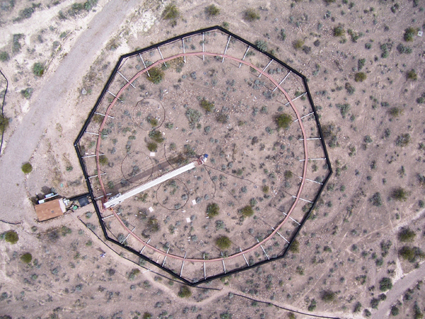 A photo from a remote-controlled helicopter of one of the test plots. The white spokes are PVC pipes through which CO2-enriched air was pumped. (Credit: Lynn Fenstermaker/Desert Research Institute)