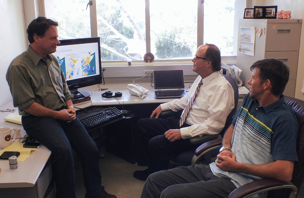 Chris Funk, Joel Michaelsen, Greg Husak (left to right) in Funk's office looking at CHIRPS data.  (Credit: USGS)