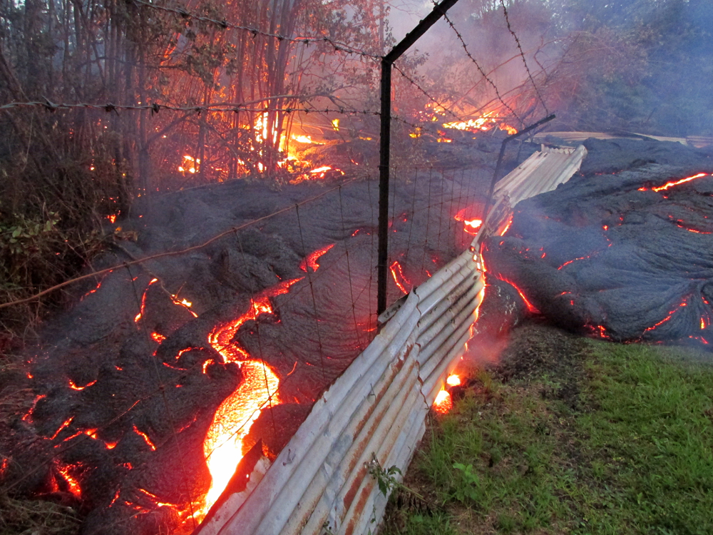 Oct. 31: Lava passes through a fence marking private property (Credit: USGS HVO)