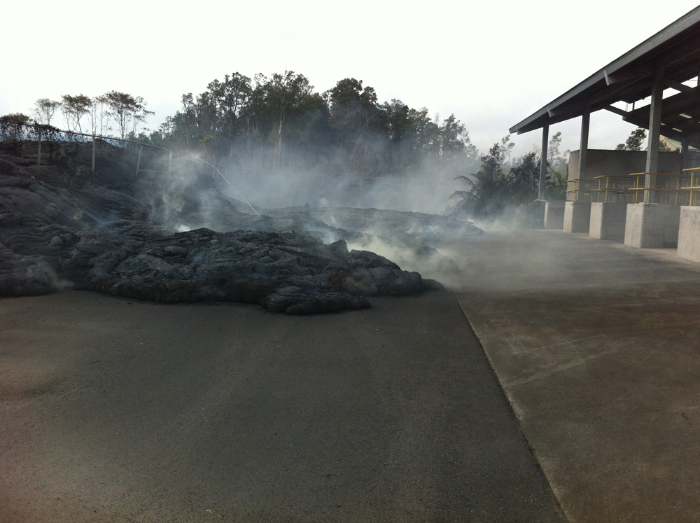 Nov. 13: Lava passed through a chain-link fence into a transfer station, where it burned the asphalt.  (Credit: USGS HVO)