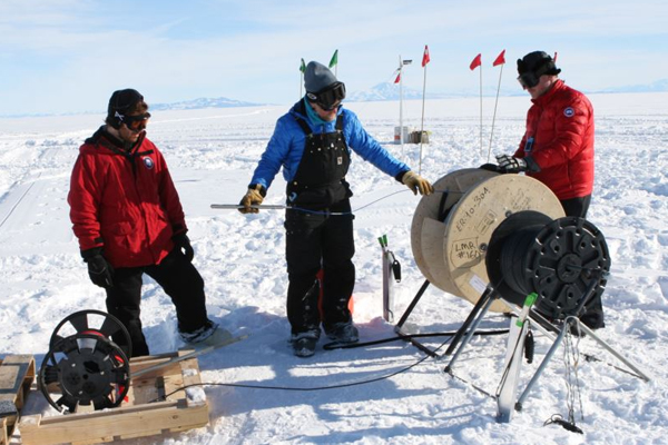Fiber optic cables and pressure sensors were lowered down into holes drilled in the ice. (Credit: Victor Zagorodnov)