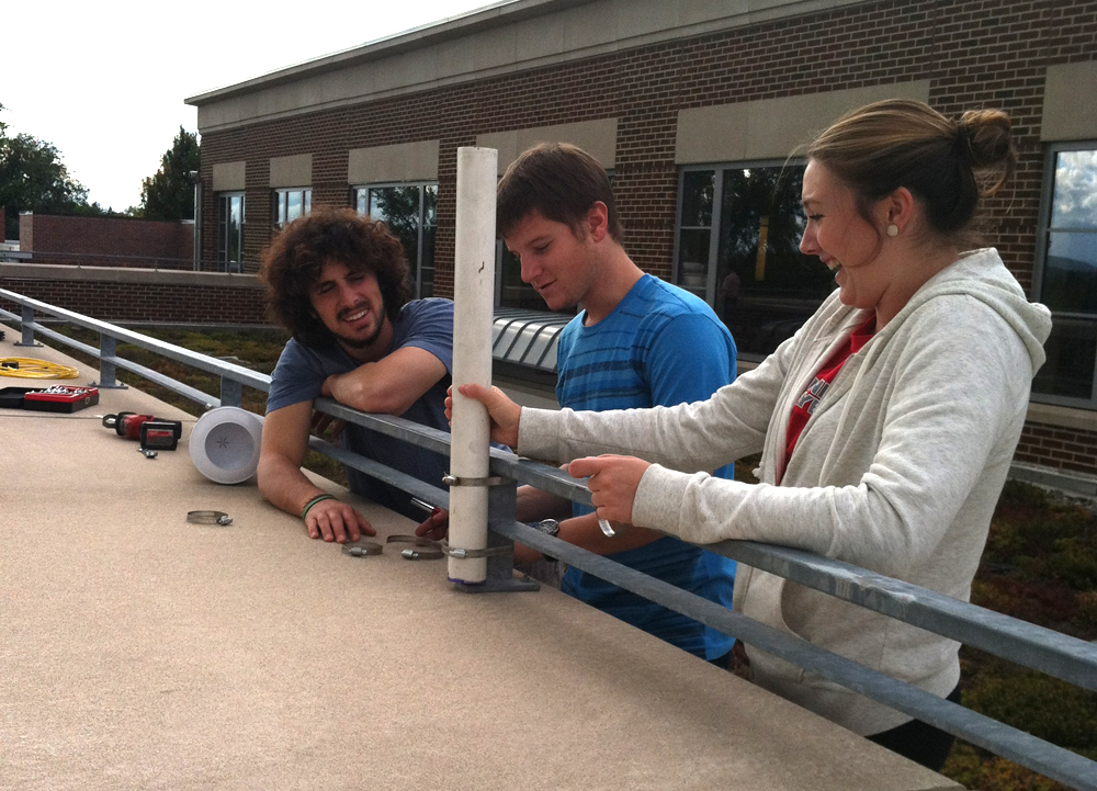 Muhlenberg students installing a rain gauge for the green roof monitoring system. (Credit: David Rabold)