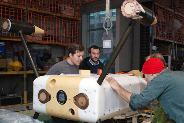 University of Washington researchers prepare to test the Millennium Falcon ROV and Adaptable Monitoring Package in a tank on campus. (Credit: Applied Physics Lab, U. Washington)