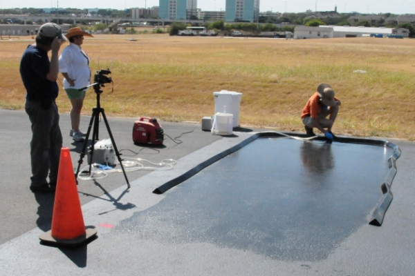 USGS researchers collected runoff samples from pavement sealed with refined coal tar in Austin, Texas in 2011. (Credit: USGS)