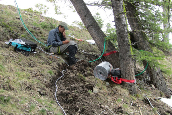 John Whiting works on wiring at a snow-dominated sap flow site within Pioneer Creek Watershed. (Credit: Jesse Bennett)