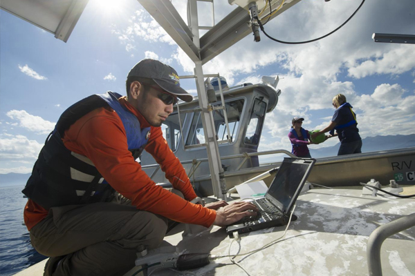 UC Davis researcher Shohei Wantanabe gathers data from a NASA Jet Propulsion Lab research buoy. (Credit: UC Davis)