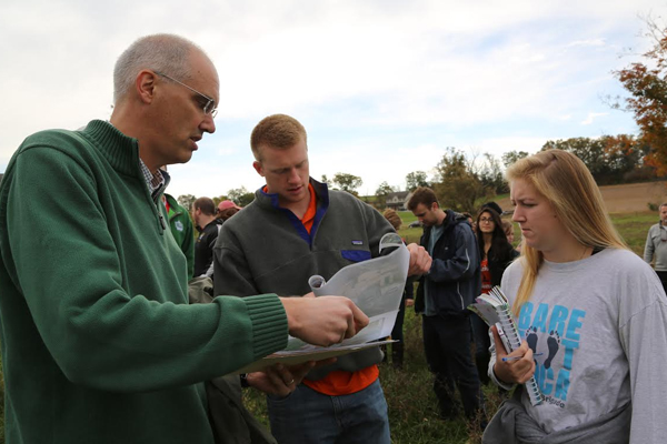 Richard Crago (left) reviews a map with Bucknell University students. (Credit: Bucknell University)