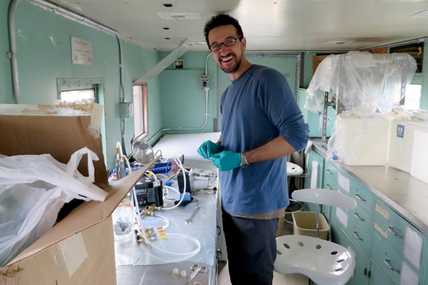 Postdoctoral Researcher Charles Flower collects isotope measurements in the lab trailer at Toolik Lake. (Credit: Miquel Gonzalez-Meler)
