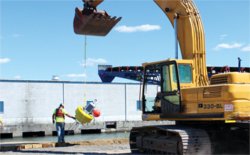 Deploying a data buoy at a dredging site.