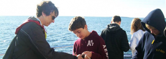 Rogers City middle school students gather data in Lake Huron near the mouth of the Trout River