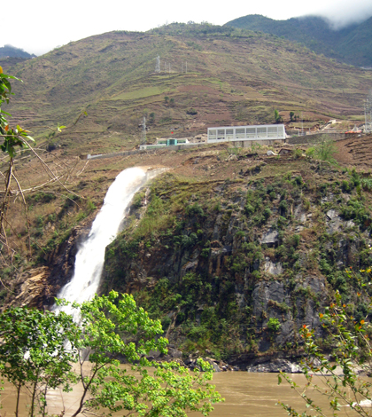 A small hydropower plant in Fugong County discharges water from a tributary into the main channel of the Nu River. (Credit: Kelly Kibler)