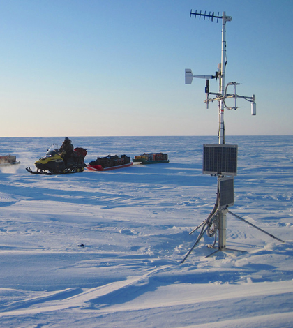Snowmobile expedition checks on a weather station in the USGS polar Alaska climate and permafrost monitoring network (Credit: Frank Urban)