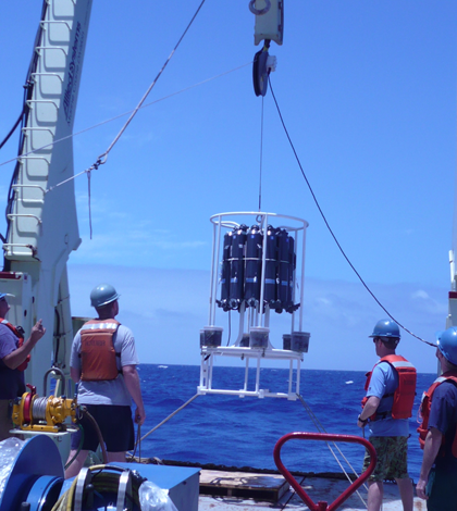 WHOI researchers lower a trace metal rosette (Credit: Emily Nahas, University of Washington)