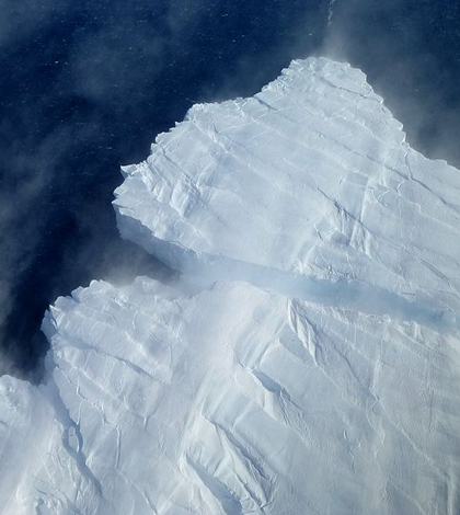 A nascent iceberg breaks off Pine Island Glacier's calving front. (Credit: NASA)
