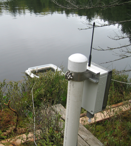 The wetland observatory's in-lake evaporation pan and its on-shore microprocessor radio device