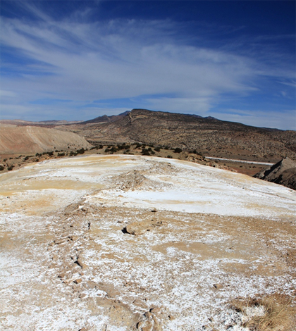 View from the top of the spring mounds near San Ysidro, N.M., looking north toward the Nacimiento Range. The range is bounded on the west by the Nacimiento Fault. In the foreground is the fissure along which the springs are aligned. (Credit: Laura Crossey)