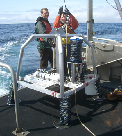 Justin Brodersen and Kim Page-Albins (OSU) in 2009 with instrument mooring before deployment 5 miles offshore of Yachats, Ore. (Credit: Oregon State University)