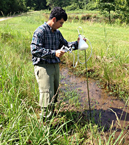 Princeton sophomore David Hoyos collects environmental samples during an eight-week-long research project to study pollution of the Mississippi River Delta (Credit: Devika Balachandran)
