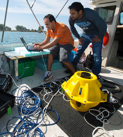 Electrical engineering graduate students Hovannes Kulhandjian and Zahed Hossain in the lab boat of Tommaso Melodiaís WINES Lab Research on Lake Erie (Credit: Douglas Levere)