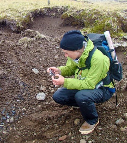 Caroline Funk examines a site on Kiska Island (Credit: University at Buffalo)