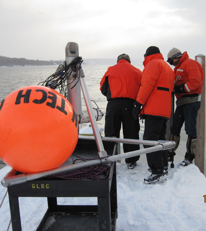 A crew deploys the under-ice observatory in the Portage Waterway (Credit: Guy Meadows)