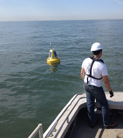 The GLERL crew deploying one of the new small experimental buoys on Lake Erie (Credit: NOAA GLERL)