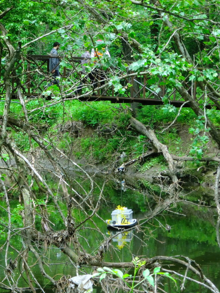 The custom floating sensor platform making its way down Indian Creek (Credit: Guy Foster/USGS) 