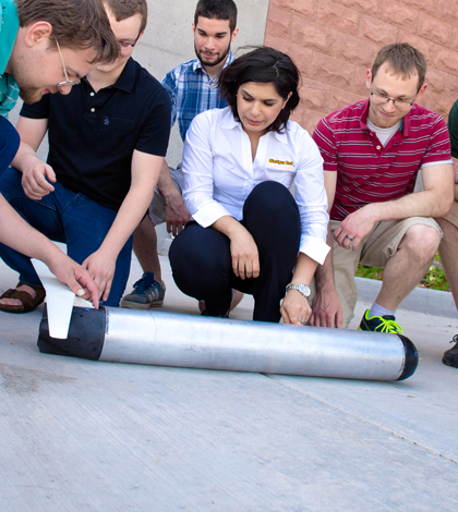 Nina Mahmoudian and students from her lab along with the ROUGHIE glider prototype. (Credit: Sarah Bird/Michigan Tech)