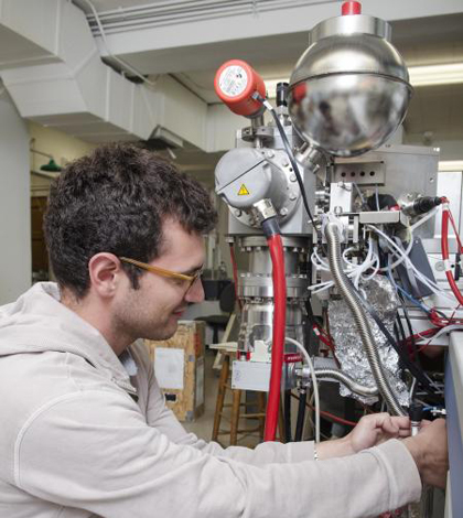 Daniel Stolper introducing a sample of methane into the mass spectrometer. (Credit: Caltech)