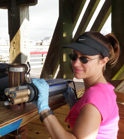 Danielle Doremus at work with a multi-parameter water quality sonde (Credit: Scott Kindelberger)