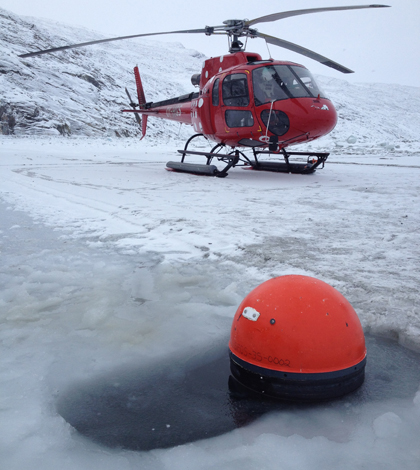 Researchers used a helicopter and boat to deploy 14 drifters between 2011 and 2013. (Credit: Kunuk Lennert, Greenland Climate Research Center)
