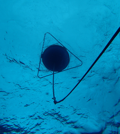 A view from below of the wave buoy bobbing off the coast of Hawaii’s Majuro Atoll (Credit: PacIOOS)