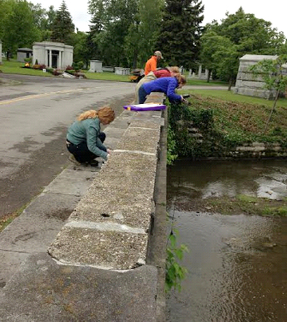 Researchers use a YSI handheld meter to take measurements of water quality. (Credit: Chris Murawski / Buffalo Niagara Riverkeeper)