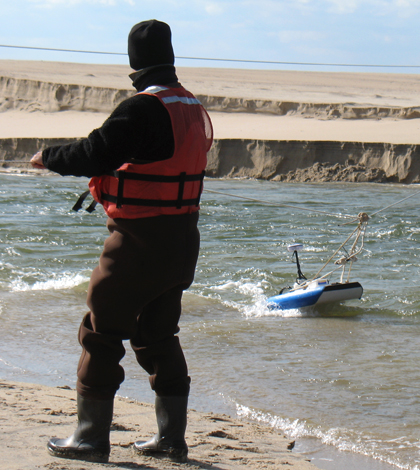 Researchers use a RiverSurveyor to collect data at a former Navy bombing practice site. (Credit: David Walsh)