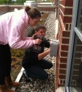 Muhlenberg College students install a junction box for the green roof monitoring system. (Credit: David Rabold)