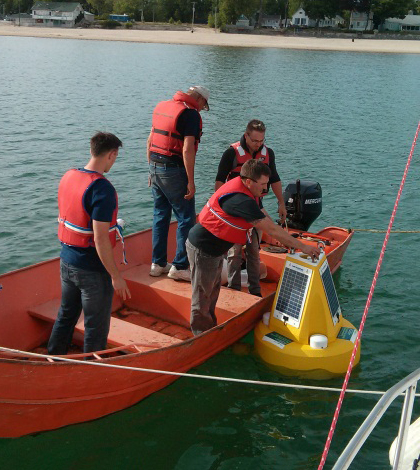 A Niagara Region crew deploys a water quality data buoy at one of the beaches the test for swimmer safety. (Credit: Doug Nguyen)