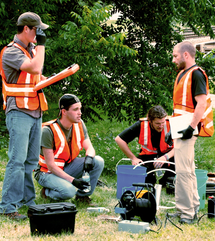 Western Michigan students use a groundwater pump. (Credit: Tom Howe, Western Michigan University)