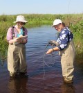 Suzanne Gray (right) and Tiffany Atkinson, a student, collect environmental data with a YSI Pro2030 in a swamp in western Uganda. (Credit: Ohio State University)