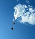 A large plastic research balloon launched by the Montana Space Grant goes up into the sky. (Credit: Berk Knighton / BOREALIS)