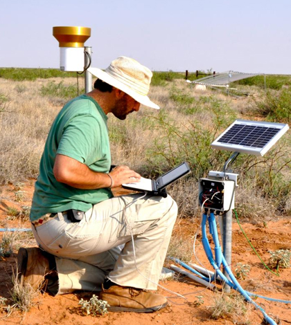 Laureano Gherardi, an ASU School of Life Sciences postdoctoral research associate, takes measurements during a six-year study on grasslands and the effects of weather extremes. (Credit: Osvaldo Sala / Arizona State University)
