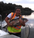 Researcher Kelsie Murchy with a bighead carp. (Credit: Brooke Vetter)