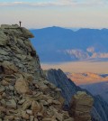 A Stanford University researcher stands on a peak in the Sierra Nevada mountain range. New evidence shows the California mountain range is 40 million years old, much older than previously thought. (Credit: Hari Mix / Stanford University)