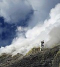 Tobias Fischer and other gas chemists conducted some of the most dangerous work during the expedition to obtain samples of toxic gases from the volcano summits. Fischer is sampling 300-degrees-Celsius hot gas vents at the summit of Gareloi Volcano in the Western Aleutians. This volcano has never before been sampled for gases. (Credit: Taryn Lopez / University of Alaska)